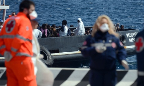 An italian tugboat carrying immigrants arrives at Messina in Sicily on Wednesday.