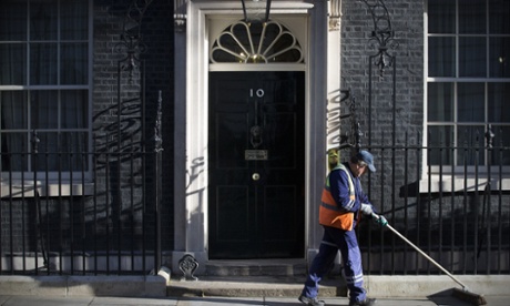 A street sweeper works outside the 10 Downing Street door