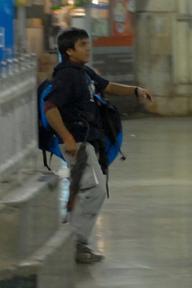 A gunman walks through Chhatrapati Shivaji Terminus on 26 November, 2008.