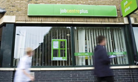 Job seekers walk past a jobcentre