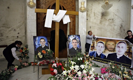 Photographs of slain Iraqi priests at a church in Baghdad