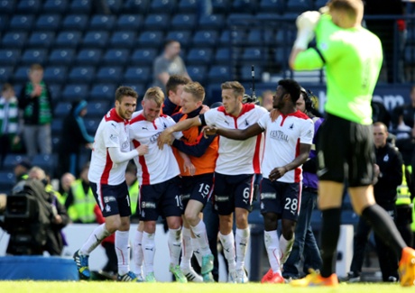 Falkirk players mob goalscorer Craig Sibbald after beating Hibernian at Hampden Park.