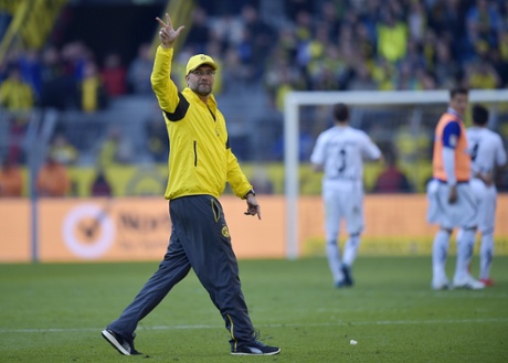 Dortmund's head coach Juergen Klopp shows three fingers to supporters after beating Paderborn 3-0.