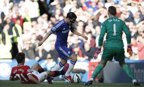 Ander Herrera slides to try and block a shot from Chelsea midfielder Cesc Fabregas.