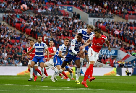 Gabriel Paulista heads at goal under pressure from Nathaniel Chalobah.