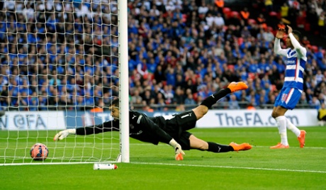 Reading goalkeeper Adam Federici scrambles for the ball after letting the shot from Arsenal's Alexis Sanchez through his legs for their second goal.