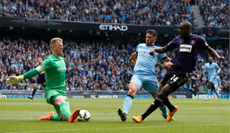 Joe Hart saves a shot from Carlton Cole.