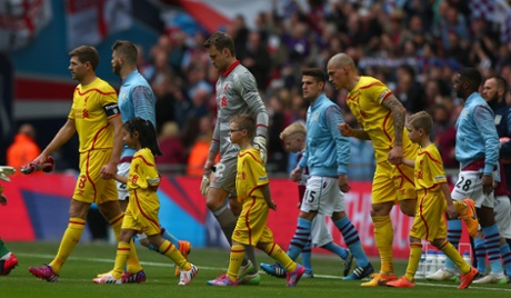 Steven Gerrard leads the teams out.