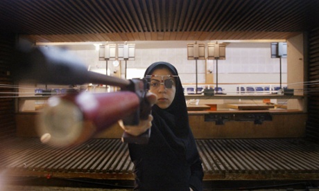 In this archive photo, Iranian shooter Nassim Hassanpour aims during training at Tehran' Azadi Stadium.