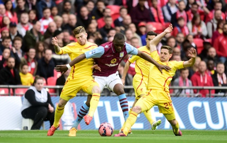 Christian Benteke sandwiched by Alberto Moreno and Joe Allen.