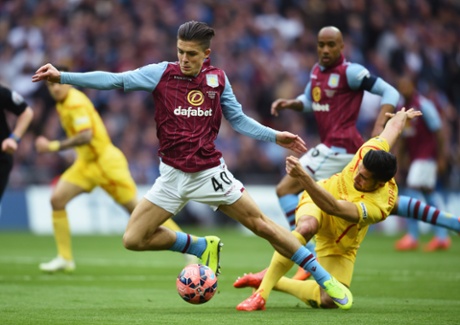 Jack Grealish is tackled by Emre Can.