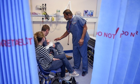 A doctor attends to a baby in Wigan’s Royal Albert Edward Infirmary. Labour claims that out of 115 Tory councillors surveyed, 26 want charges for NHS services.