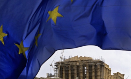 The European Union flag waves in front of the Parthenon Temple on Acropolis Hill in central Athens, Greece.