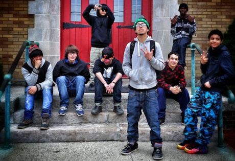 Newburgh teenagers on a break from school flash gang signs.