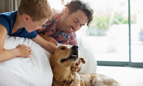 A father and son with their dog