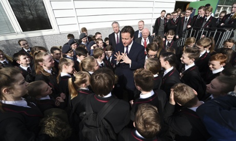 David Cameron, center, talks with pupils during a visit to the Kings Leadership Academy in Warrington, northwest England.