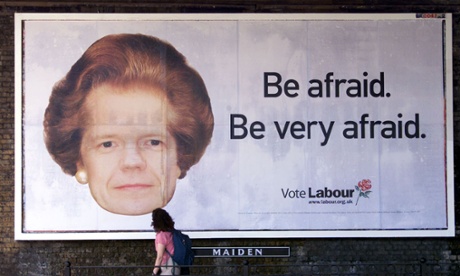 A passing woman looks up at a Labour Party election poster showing Conservative leader William Hague with a the haircut of former prime minister Margaret Thatcher