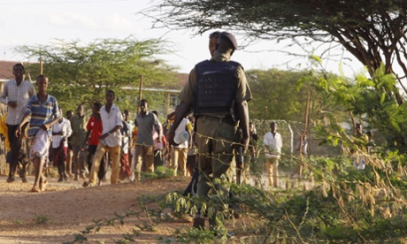 A member of Kenya's defence forces secures the area of the Garissa University college