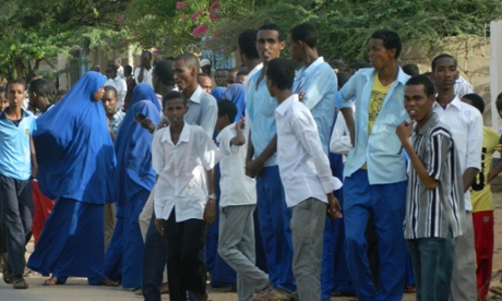 Residents watch at a distance from the university