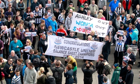 Newcastle fans with banners in reference to owner Mike Ashley.