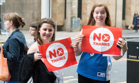 two girls hold signs