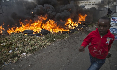 TOPSHOTS A child runs pass burning tires