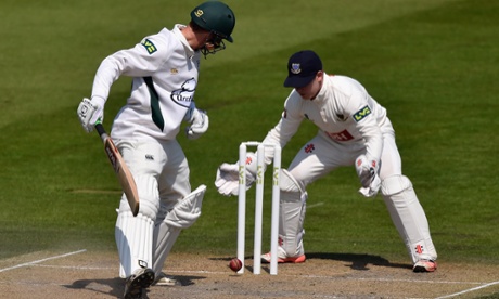 Richard Oliver of Worcestershire and Sussex wicketkeeper Ben Brown watch as the ball hits the base of the stumps without dislodging the bails at Hove.