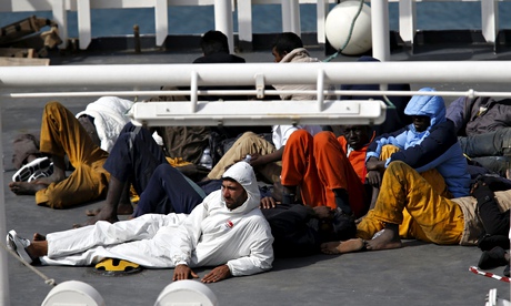 Surviving immigrants lie on the deck of Italian coastguard ship Bruno Gregoretti in Senglea