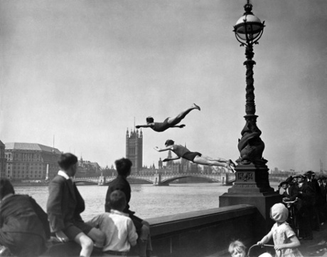 Two divers jumping off the Embankment into the River Thames in London, near Westminster bridge, July 1934.