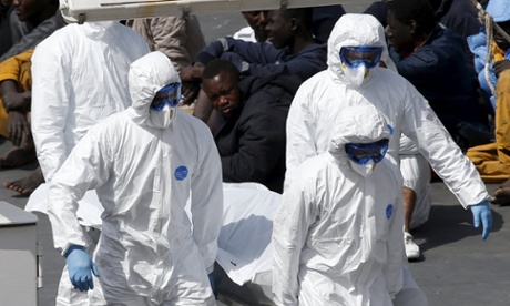 Maltese military personnel carry the body off the Italian coastguard ship Bruno Gregoretti at Valletta on Monday.