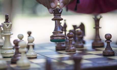 Hand moving chess piece on board, close upkennychess