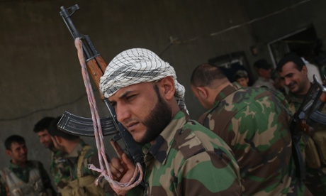 Volunteers from a Shia militia gather after an exchange of fire with Isis fighters on the frontline in Anbar Province, Iraq.