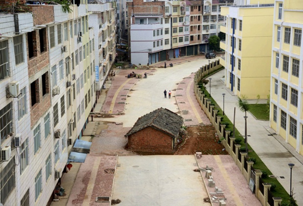 A nail house sits in the middle of a road under construction in Nanning