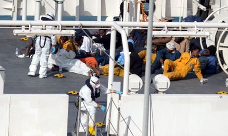 Survivors of an accident in which a fishing boat carrying migrants capsized off the Libyan coast, sit on the deck of the Italian Coast Guard vessel Bruno Gregoretti at Boiler Wharf, Senglea in Malta on April 20, 2015. More than 700 people are feared dead following the capsize off Libya of a fishing boat that had been crammed with migrants trying to reach Europe.