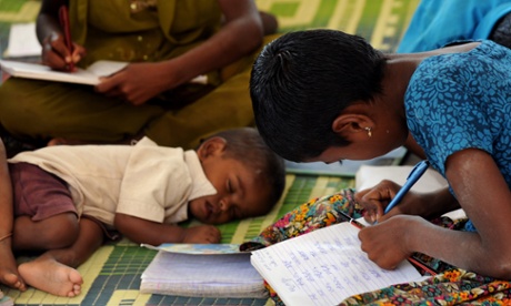 Children of Indian migrant labourers attend a 'Tent School' run by a non-governmental organisation (NGO) 'Concern for Working Children (CWC)' in Bangalore
