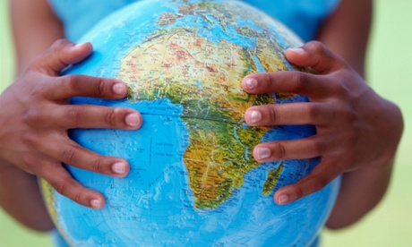 Young girl holding a globe in her hands