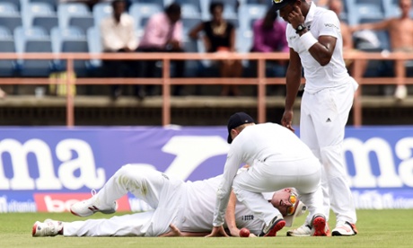 Ben Stokes lays on the ground after being hurt while trying to field a ball played by Marlon Samuels. He was back on his feet after treatment by the physios.