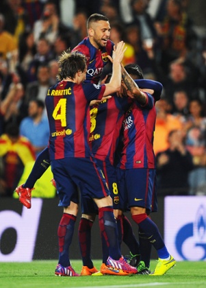 Then is swamped by his team-mates after stroking the ball into the empty net.