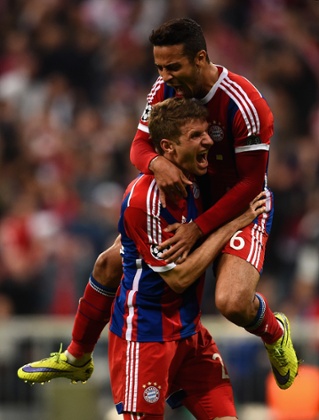Thomas Mueller celebrates his goal with Thiago Alcantara, whose goal started the rout.