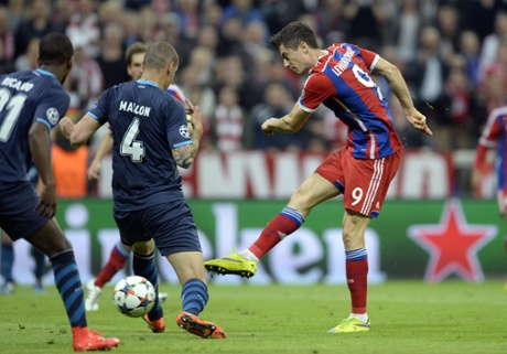 Robert Lewandowski fires his shot goalwards ...