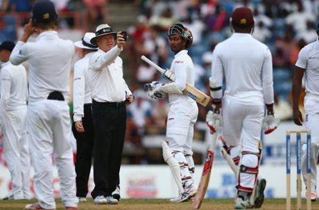 Denesh Ramdin of West Indies looks at umpire Bruce Oxenford as play is suspended due to bad light.