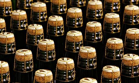 Under pressure: bottles of sparkling wine wait for a foil cap to be added.