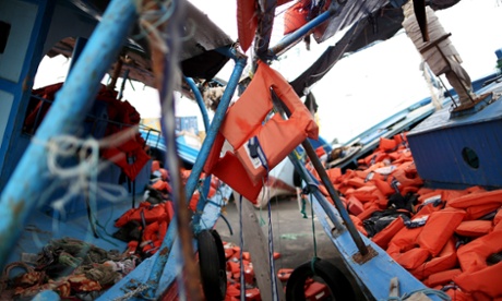Life jackets used by migrants are seen left on two flotsams at the Sicilian harbor of Pozzallo, February 16, 2015. Better weather since last week has encouraged migrants to make the perilous journey from North Africa, where a breakdown of order in Libya has made it almost impossible to police the traffickers who pack people onto rickety boats.