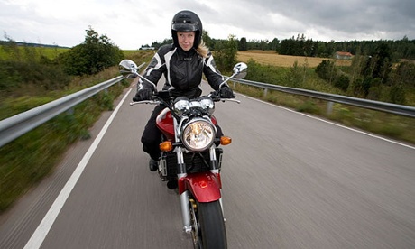 A woman riding a motorbike