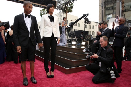 Pharrell Williams, left, and Helen Lasichanh arrive at the Oscars in March.