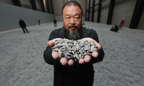 Chinese Artist Ai Weiwei holds some seeds from his Unilever Installation 'Sunflower Seeds' at The Tate Modern, 2010.