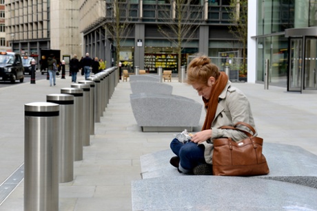 A woman eats her lunch on a counter-terror block in London