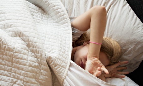Caucasian teenage girl sleeping in bed