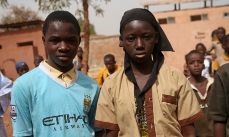 Fanta Bamba, 14, right, says her favourite subject is English. Bourama Fomba, 13, is a Man City fan and keen football player. Both are members of the school sanitation club.