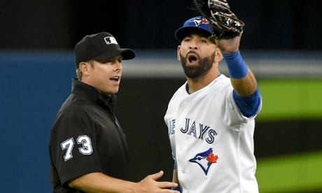 Toronto Blue Jays right fielder Jose Bautista is restrained by second base umpire Tripp Gibson as he engages in a verbal altercation with Baltimore Orioles players prior to the eighth inning at Rogers Centre.